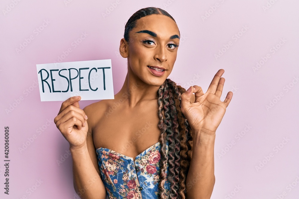 Hispanic transgender man wearing make up and long hair holding respect message doing ok sign with fingers, smiling friendly gesturing excellent symbol Hispanic transgender man wearing make up and long hair holding respect message doing ok sign with fingers, smiling friendly gesturing excellent symbol