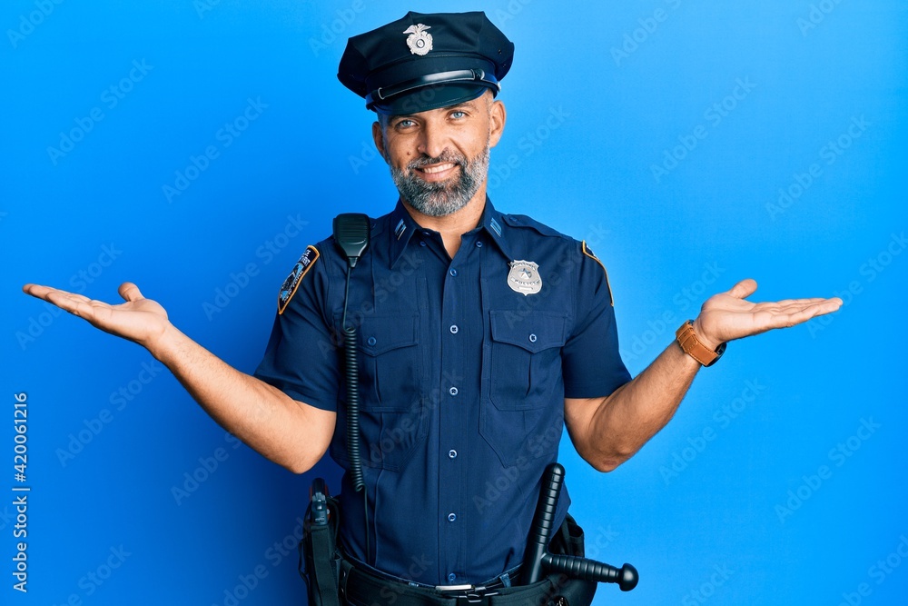 Middle age handsome man wearing police uniform smiling showing both hands open palms, presenting and advertising comparison and balance Middle age handsome man wearing police uniform smiling showing both hands open palms, presenting and advertising comparison and balance