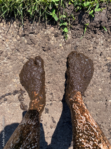 Feet and legs covered in mud