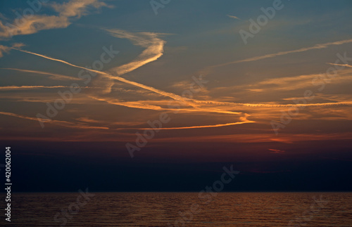Washed out contrails at sunset