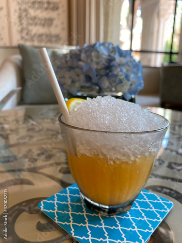 Non-alcoholic welcome drink in the hotel with a straw and crushed ice