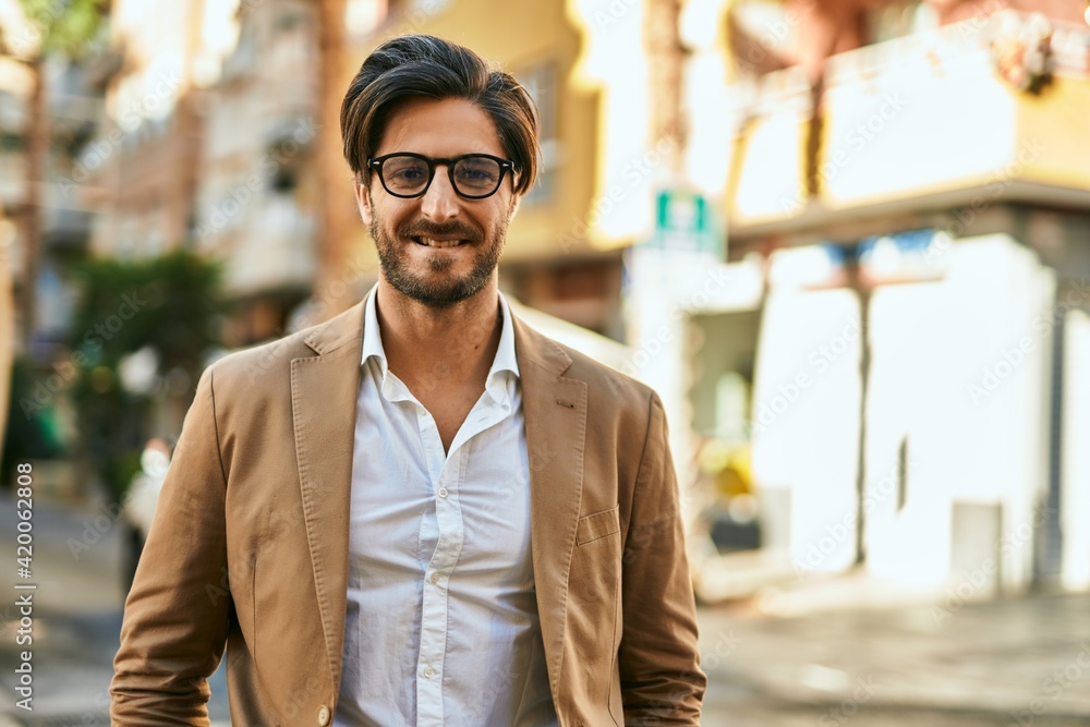 Young hispanic businessman smiling happy standing at the city. Young hispanic businessman smiling happy standing at the city.