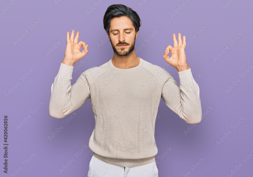 Naklejka premium Young hispanic man wearing casual clothes relax and smiling with eyes closed doing meditation gesture with fingers. yoga concept.