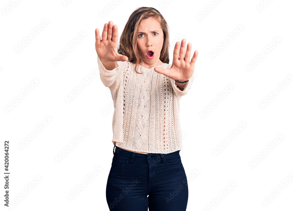 Young beautiful blonde woman wearing casual sweater doing stop gesture with hands palms, angry and frustration expression Young beautiful blonde woman wearing casual sweater doing stop gesture with hands palms, angry and frustration expression