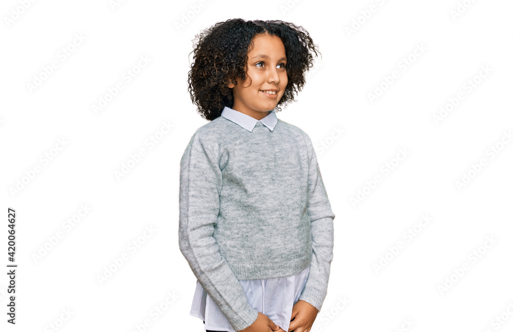 Young little girl with afro hair wearing casual clothes looking away to side with smile on face, natural expression. laughing confident. Young little girl with afro hair wearing casual clothes looking away to side with smile on face, natural expression. laughing confident.
