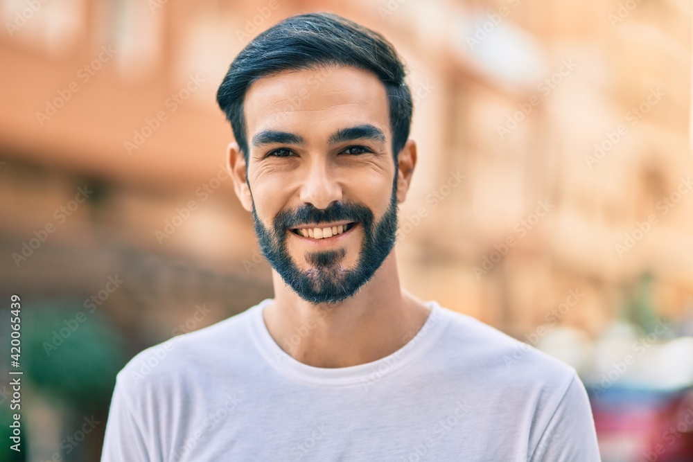 Young hispanic man smiling happy standing at the city. Young hispanic man smiling happy standing at the city.