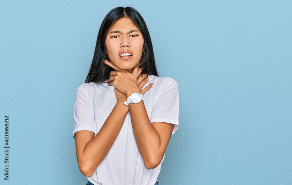 Beautiful young asian woman wearing casual white t shirt shouting suffocate because painful strangle. health problem. asphyxiate and suicide concept. Beautiful young asian woman wearing casual white t shirt shouting suffocate because painful strangle. health problem. asphyxiate and suicide concept.