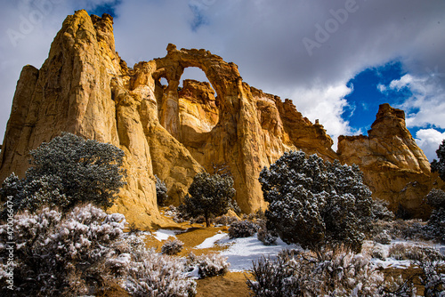 Grosuenor Arch in Southern Utah. Natural arch against blue sky with white clouds