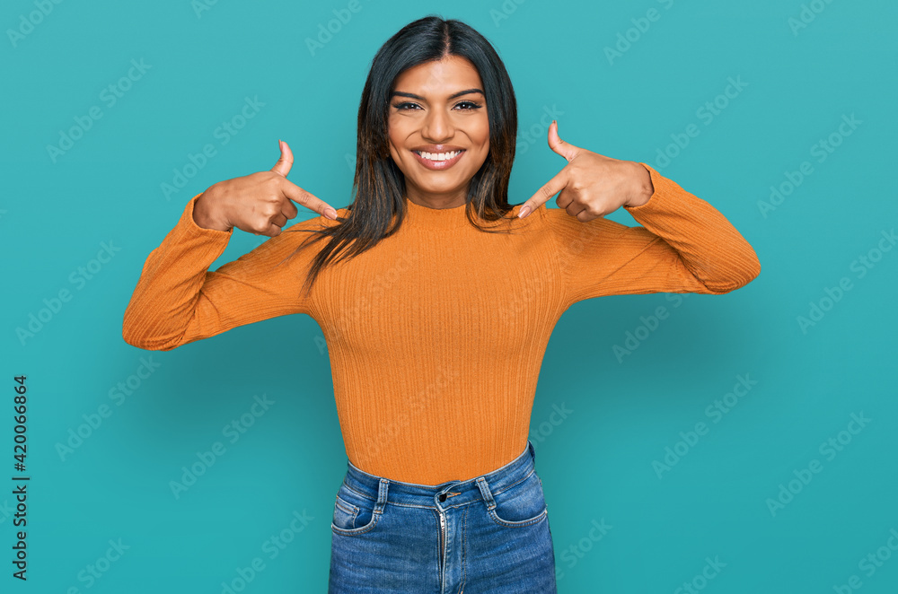 Young latin transsexual transgender woman wearing casual clothes looking confident with smile on face, pointing oneself with fingers proud and happy. Young latin transsexual transgender woman wearing casual clothes looking confident with smile on face, pointing oneself with fingers proud and happy.