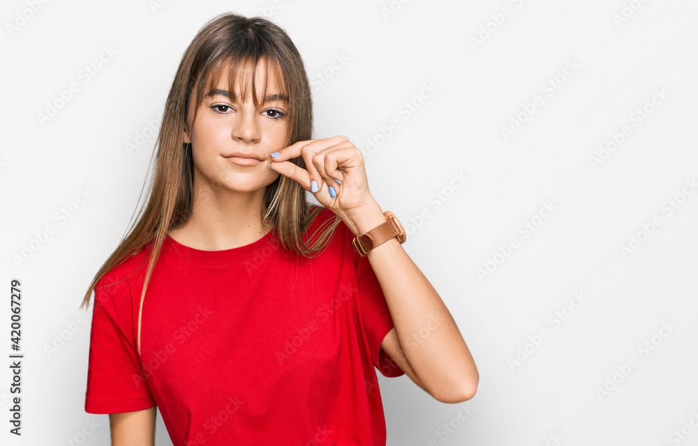 Teenager caucasian girl wearing casual red t shirt mouth and lips shut as zip with fingers. secret and silent, taboo talking Teenager caucasian girl wearing casual red t shirt mouth and lips shut as zip with fingers. secret and silent, taboo talking