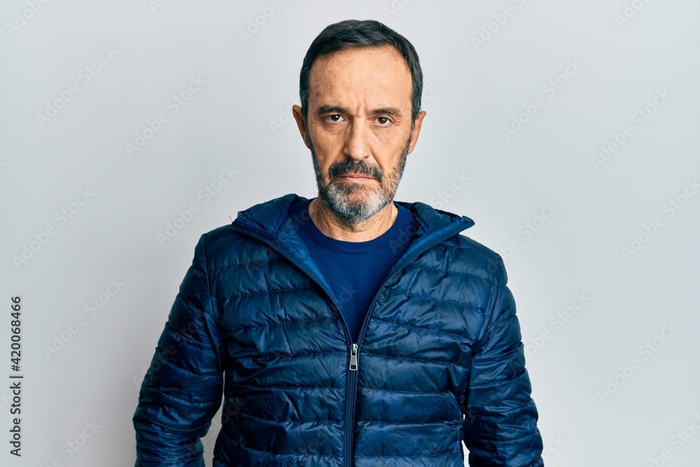 Middle age hispanic man wearing casual clothes with serious expression on face. simple and natural looking at the camera. Middle age hispanic man wearing casual clothes with serious expression on face. simple and natural looking at the camera.