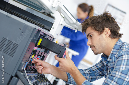 Foto printer technician mending the problem