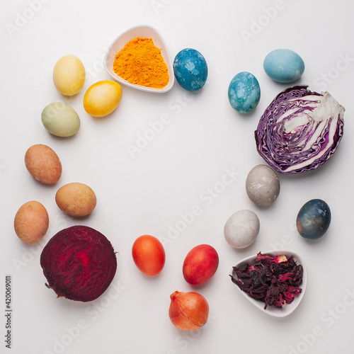 Natural dye for easter eggs - red cabbage, beetroot, carcade, turmeric and onion skin on light background