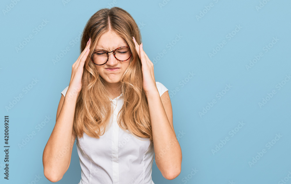Beautiful young caucasian girl wearing casual clothes and glasses with hand on head for pain in head because stress. suffering migraine. Beautiful young caucasian girl wearing casual clothes and glasses with hand on head for pain in head because stress. suffering migraine.