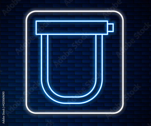 Glowing neon line Bicycle lock U shaped industrial icon isolated on brick wall background. Vector