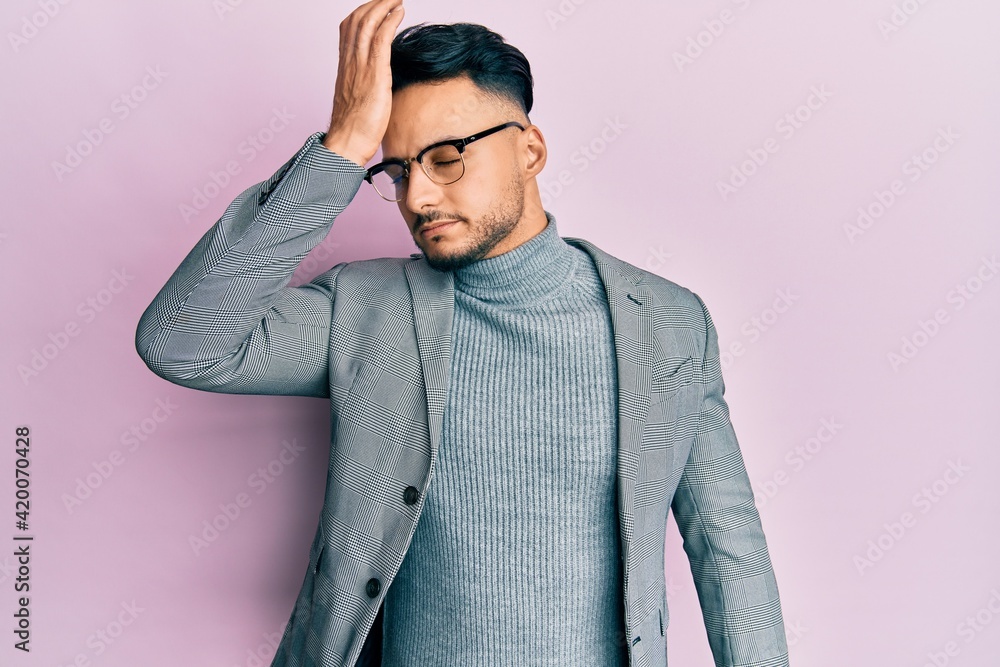 Young arab man wearing business clothes surprised with hand on head for mistake, remember error. forgot, bad memory concept. Young arab man wearing business clothes surprised with hand on head for mistake, remember error. forgot, bad memory concept.