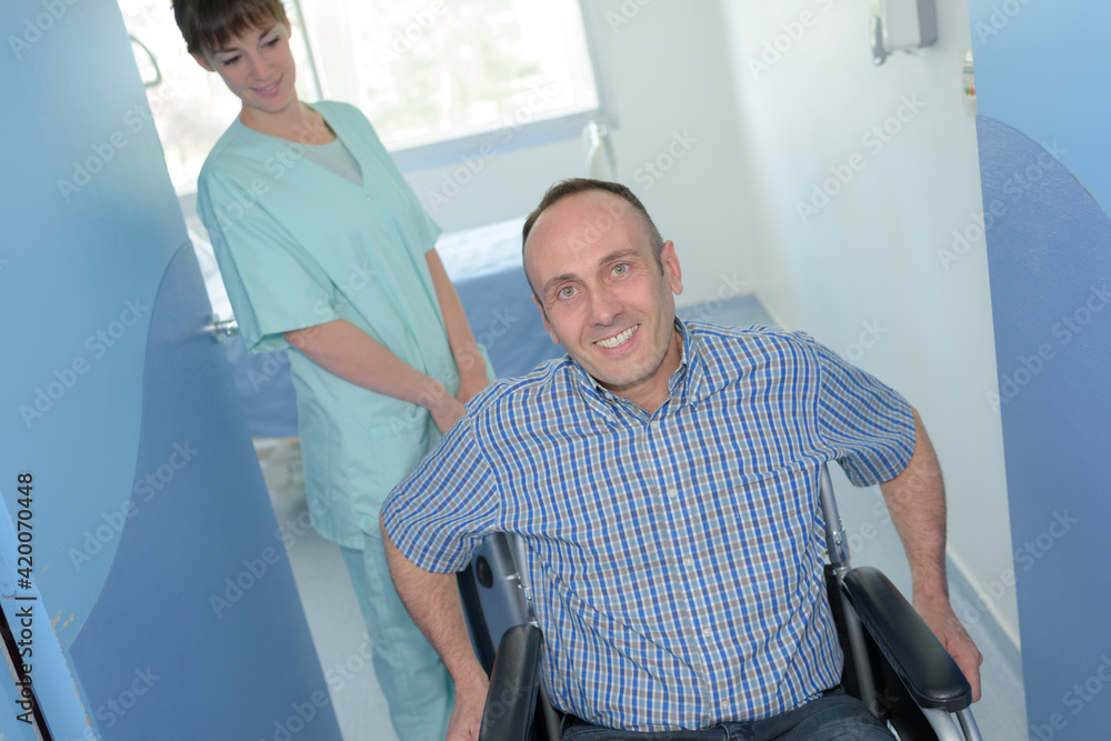 nurse pushing a patients wheelchair nurse pushing a patients wheelchair
