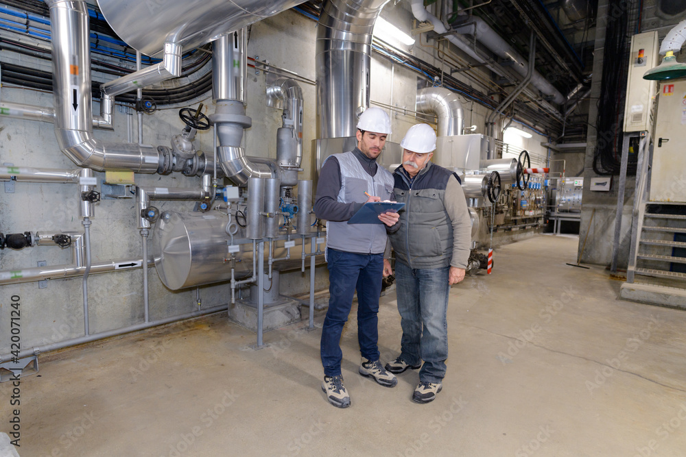 Fototapeta premium portrait of a factory engineers talking