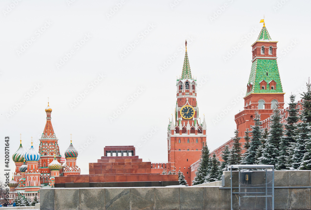 Spasskaya Tower and the Cathedral of Vasily the Blessed (Saint Basil's Cathedral) on Red square. Winter day after snowfall. Moscow. Russia Spasskaya Tower and the Cathedral of Vasily the Blessed (Saint Basil's Cathedral) on Red square. Winter day after snowfall. Moscow. Russia