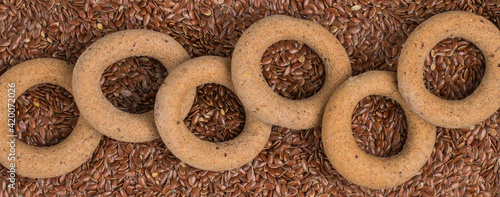 Homemade healthy little flaxseed flour bagels and flax seed. Culinary background. The concept of useful nutrition. Vegan and vegetarian cuisine. Top view, selective focus, banner, long picture