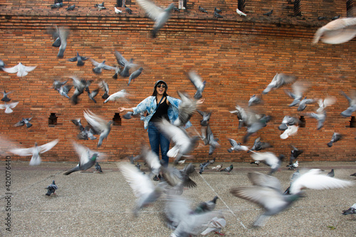 Travelers thai women people travel visit and take photo with dove birds at Thapae ancient gate or Chiang Mai old city brick walls and Tha Pae gates the most famous landmarks in Chiang Mai, Thailand photo