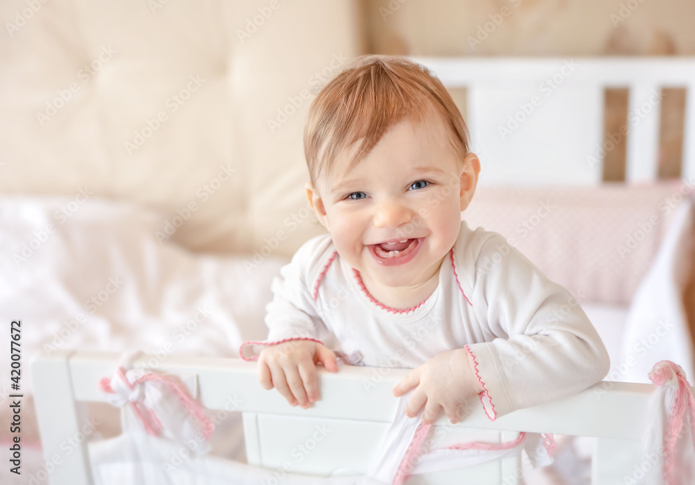 Smiling baby at home. Happy child in white nursery. Smiling baby at home. Happy child in white nursery.