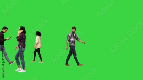 People walking in the streets, passing by Urban life concept on a Green Screen, Chroma Key.