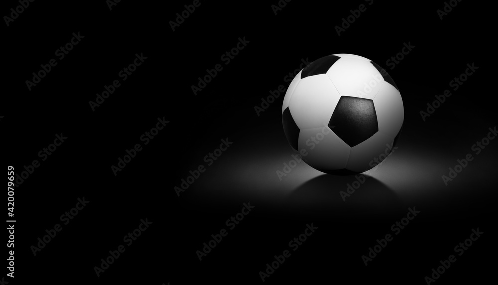 Soccer ball on black background.