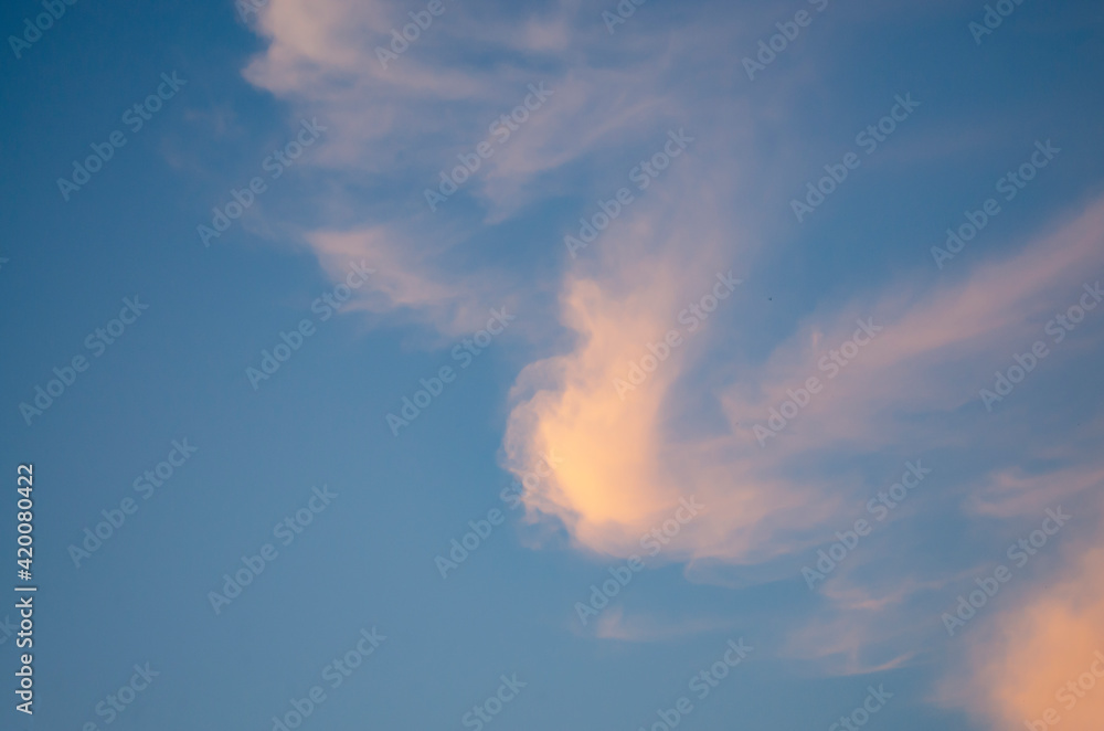 A single cloud of strange shape in the evening sky