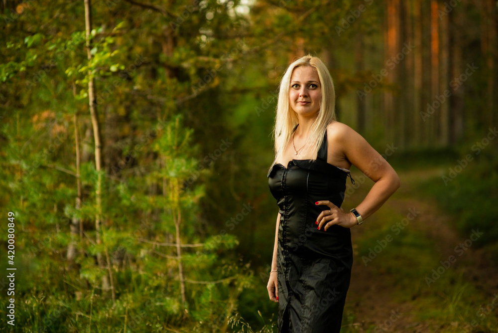 blonde girl in black dress in the woods, selective focus blonde girl in black dress in the woods, selective focus