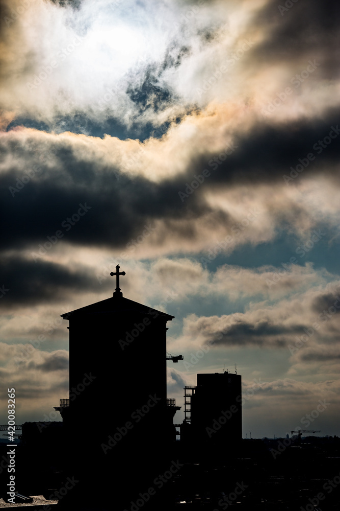 Cityscape, amazing silhouettes view over the city of Copenhagen, Denmark. Winter cloudy dark moody picturesque scene. Picture taken from Round Tower. Church tower