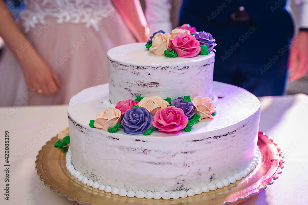 beautiful and young bride and groom tasting wedding cake beautiful and young bride and groom tasting wedding cake