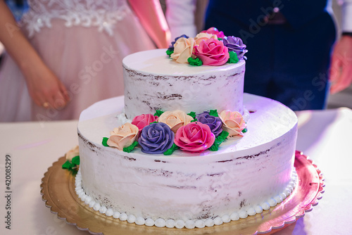 beautiful and young bride and groom tasting wedding cake