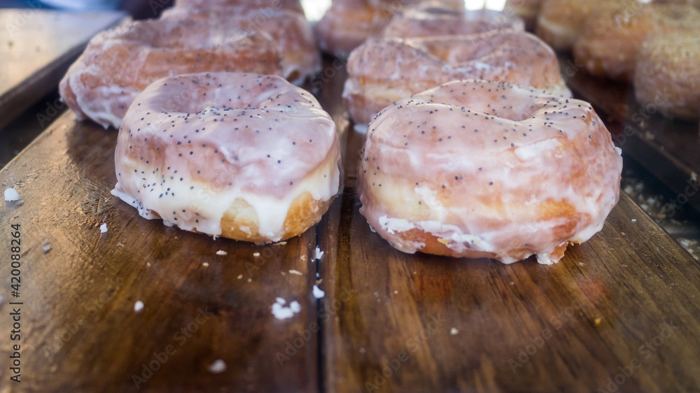 Display of delicious fresh glazed donuts with frosted icing Display of delicious fresh glazed donuts with frosted icing