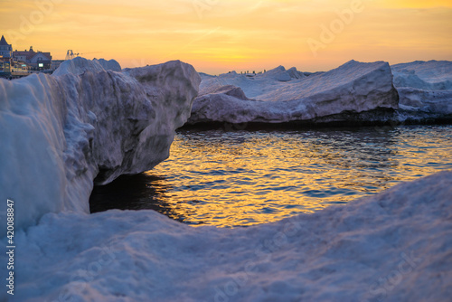 Blocks of ice on the seashore at sunset