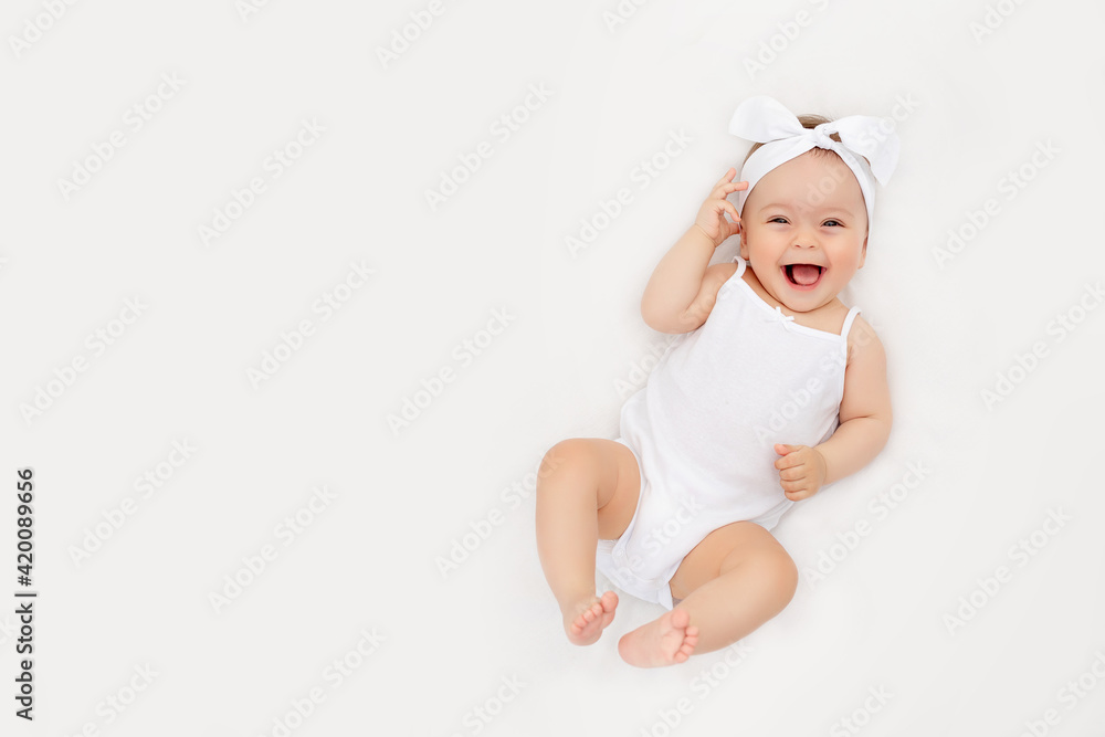 smiling newborn baby on a white bed at home, the concept of a happy, healthy baby, a place for text smiling newborn baby on a white bed at home, the concept of a happy, healthy baby, a place for text