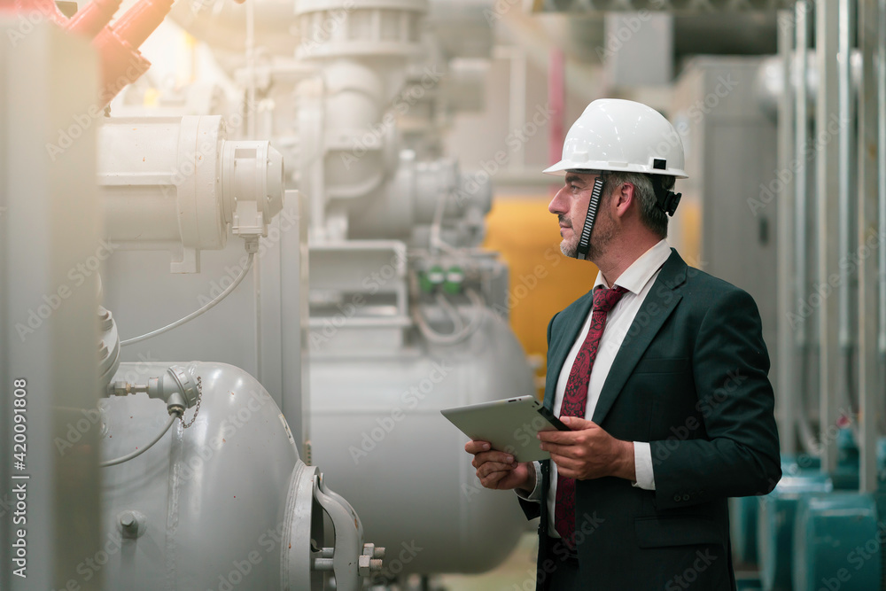 Portrait shot of senior engineer or management level inspection work in boiler room Portrait shot of senior engineer or management level inspection work in boiler room