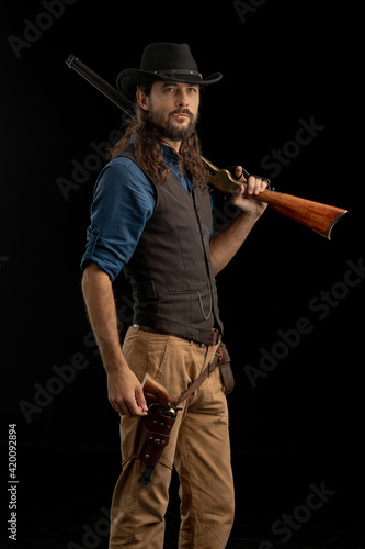Cowboy with guns. Studio shooting