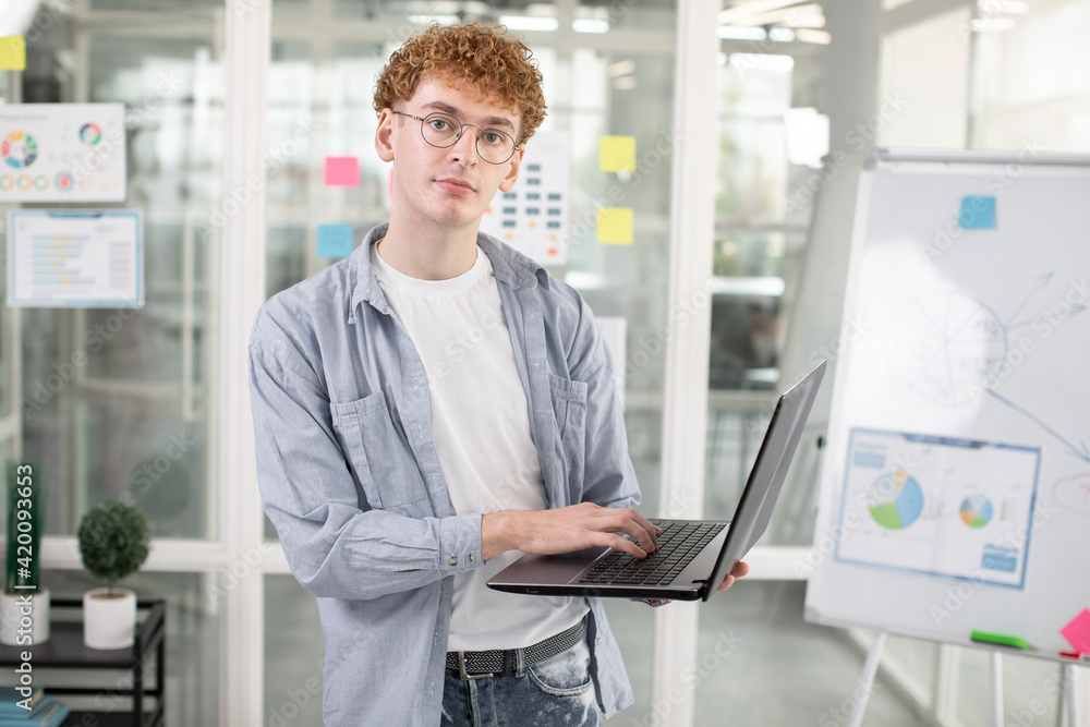 Male IT specialist using laptop for work at office