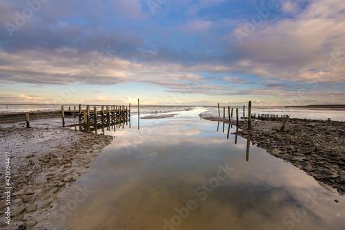Small jetty with harbor along the coastline of the wadden island of Texel