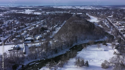 small village with beautiful winter snow and stream running through it photo