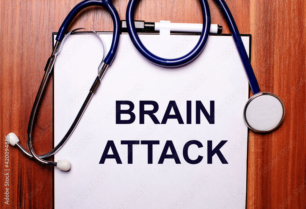On a wooden background lies a stethoscope and a sheet of paper with the inscription BRAIN ATTACK. Flat lay. Medical concept On a wooden background lies a stethoscope and a sheet of paper with the inscription BRAIN ATTACK. Flat lay. Medical concept