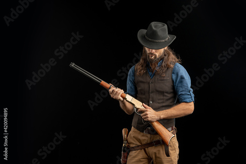 Cowboy with guns. Studio shooting