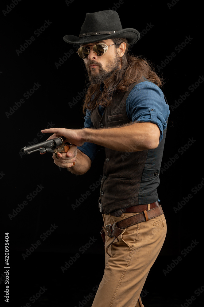 Cowboy with guns. Studio shooting Cowboy with guns. Studio shooting