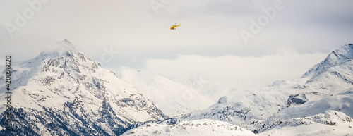 snow covered mountains and helicopter