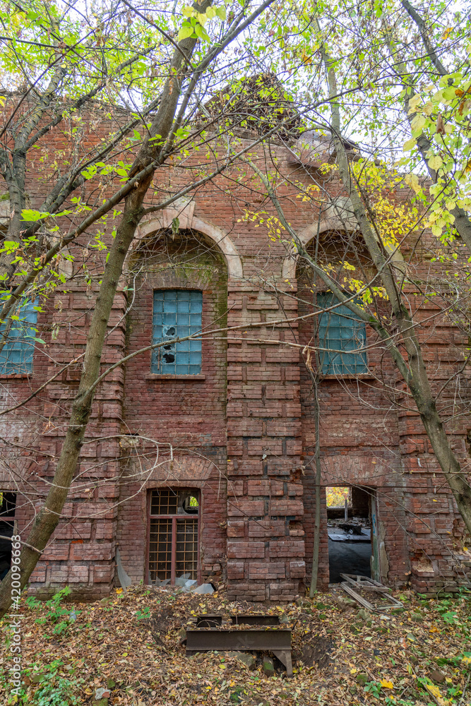 Abandoned brick factory in autumn forest