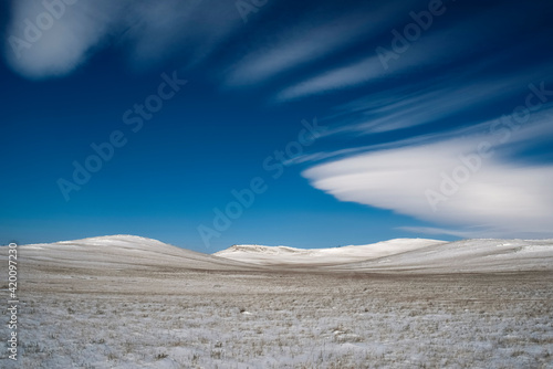 Winter snowy landscape with lenticular clouds, blue sky. Desktop wallpaper Irkutsk region, Russia