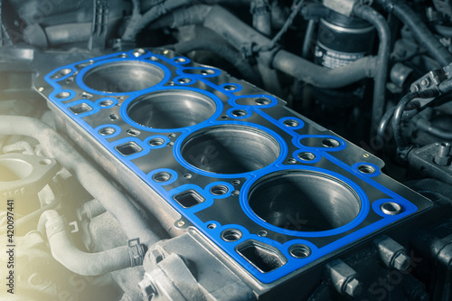 Short block with installed cylinder head gasket. Repair of a turbocharged diesel engine in a car workshop. Close up. Blur effect.