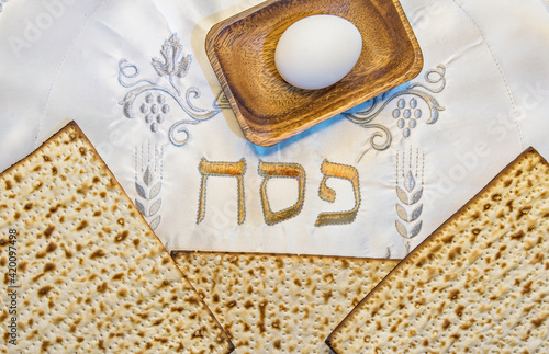 Pesah celebration concept (Jewish Passover holiday). Top view on traditional food attributes. Hebrew letters, in English translation mean as Jewish Passover photo