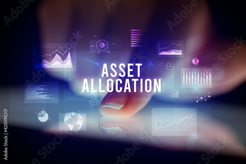 Finger touching tablet with business graphs and icons concept